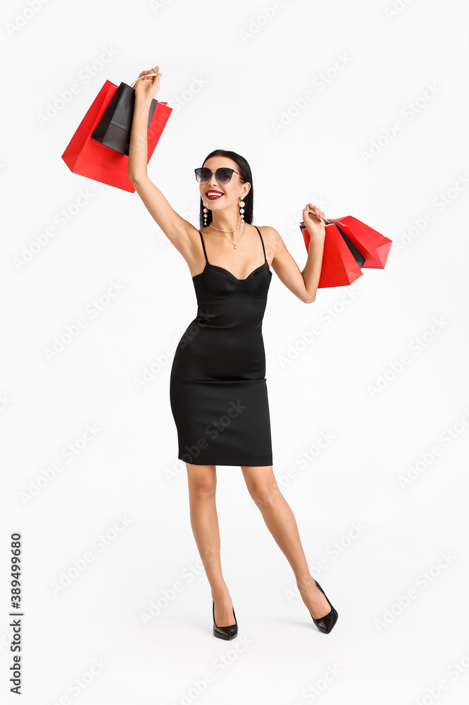 Wall mural beautiful young woman with shopping bags on white background. black friday sale