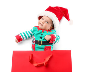 Cute little baby in Santa hat and with shopping bag on white background