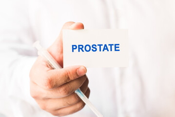 Word prostate on a white background with a syringe in hand. Preventive Medicine