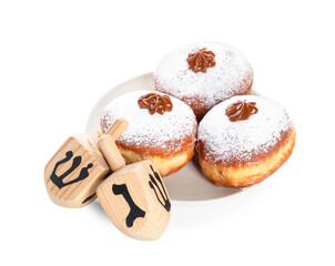 Dreidels and donuts for Hanukkah on white background