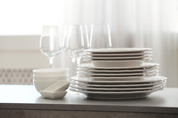 Set of clean dishware and wineglasses on table indoors