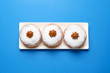 Tasty donuts for Hanukkah on color background