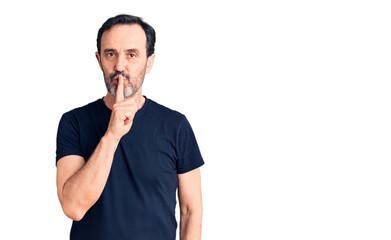 Middle age handsome man wearing casual t-shirt asking to be quiet with finger on lips. silence and secret concept.