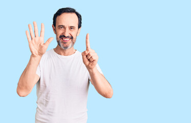 Middle age handsome man wearing casual t-shirt showing and pointing up with fingers number six while smiling confident and happy.