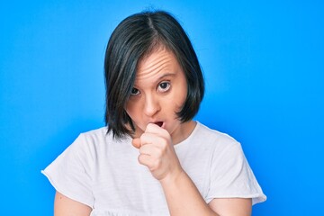 Brunette woman with down syndrome wearing casual clothes feeling unwell and coughing as symptom for cold or bronchitis. health care concept.