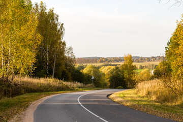 Fototapeta premium A two-lane road passing through a picturesque area. A sharp right turn on the road 