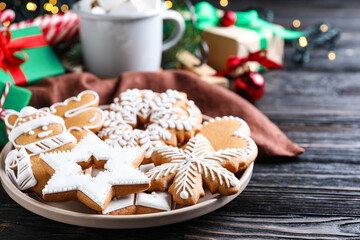 Fototapeta na wymiar Delicious Christmas cookies on black wooden table table