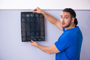 Young male doctor teacher radiologist in front of whiteboard