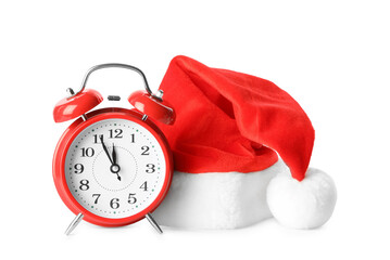 Alarm clock and Santa hat on white background. New Year countdown