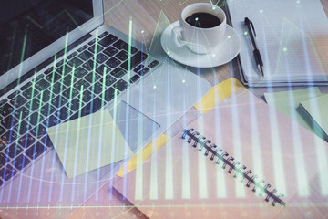 Multi exposure of forex graph drawing and desktop with coffee and items on table background. Concept of financial market trading