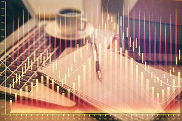 Double exposure of forex chart drawing and desktop with coffee and items on table background. Concept of financial market trading