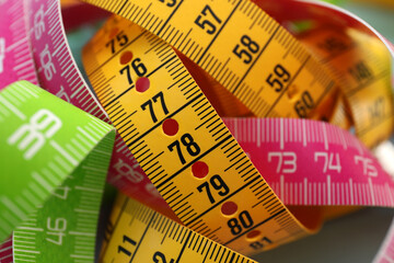 Kit of different measuring tapes as background, closeup