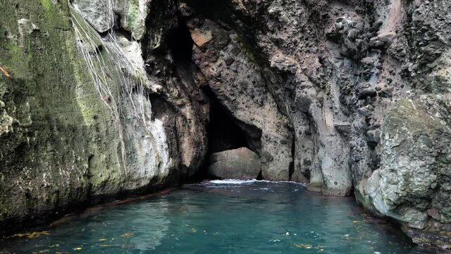 bat cave and blue lagoon rocky cliffs Martinique bat entrance 