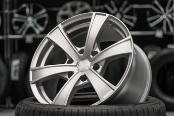 silver alloy wheel on a tire in a car spare parts store