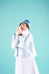 Fashion portrait of young beautiful asian muslim woman with wearing hijab on blue background. 