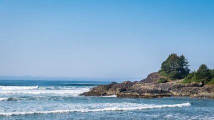 The rocky shore between Cox Bay and Chesterman Beach at the Pacific Rim National Park on Vancouver Island, British Columbia, Canada under Blue Sky