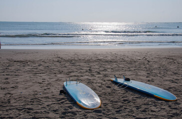 Surfboards isolated on the beach against sky.