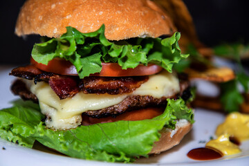 Closeup of a large burger with vegetables