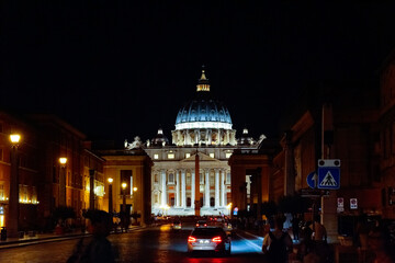Fototapeta na wymiar St peters basilica catholic church in Italy Rome during night time with lights on. Architecture and building concept.