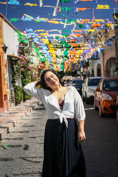 Portrait of smiling mexican woman strolling through city street