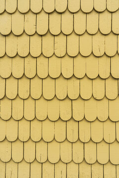 Vertical Background Of Yellow Painted Wood Half Round Shingles Siding