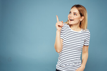 Fototapeta premium Pretty woman striped t-shirt fun emotions lifestyle blue background