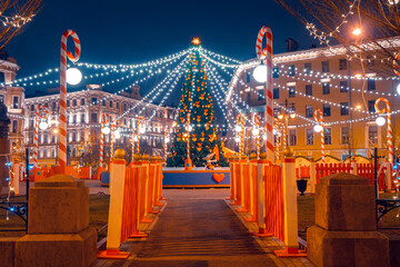 Christmas in Moscow. New Year's tree in night Russia city. The capital of Russia is decorated with garlands. Christmas spruce in the center of Moscow.