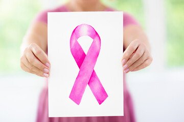 Woman holding pink breast cancer awareness sign