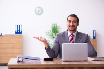 Young male employee working in the office