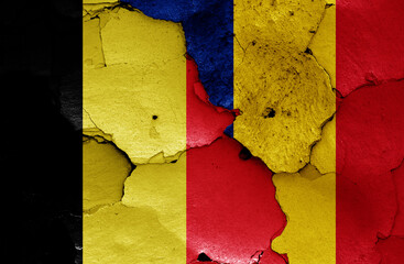 flags of Belgium and Romania painted on cracked wall
