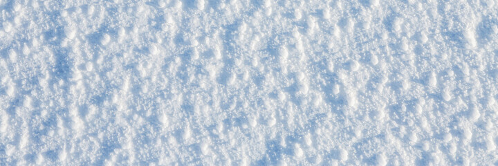 Natural snow texture. The surface of an icy snow crust. Snowy ground. Winter background with snow...