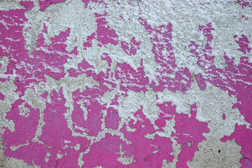 Peeling paint on the wall. Old concrete wall with cracked flaking paint. Weathered rough painted surface with patterns of cracks and peeling. High resolution texture for background and design. Closeup