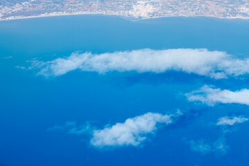 White clouds over the sea . Flying over the Mediterranean Sea