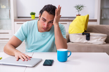 Young male parent looking after newborn at home