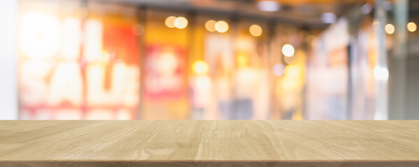 Empty wood table top and blur glass window interior shopping mall banner mock up abstract background - can used for display or montage your products.