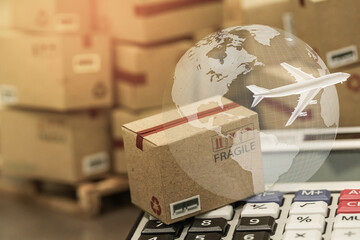 small papers boxes and calculator with a plane flies above world map. For ideas about transportation, international freight, global shipping, overseas trade, regional ,local forwarding.