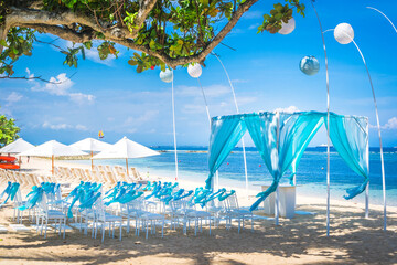 bali tropical destination beach wedding with canopy, chairs and decoration and the sea