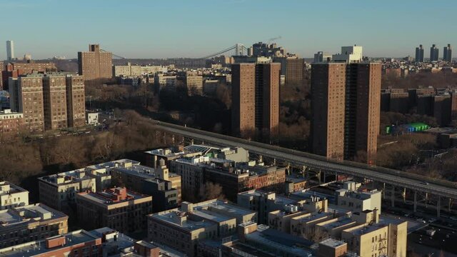 Aerial trucking shot across the upper end of the Harlem neighborhood of New York City with the George Washington Bridge far in the background