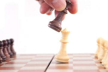 Queen chess pieces in a duel on a chess board