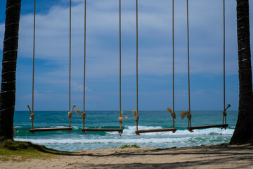 Wooden swing and hanging chair, sea view