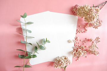 Empty cards with white flowers and green leaves on pink background....