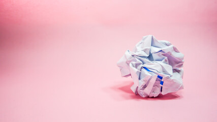 Crumpled paper in pink background