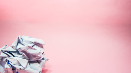 Crumpled paper in pink background
