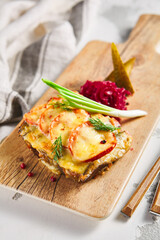 Open grilled cheese sandwich with fish and tomatoes