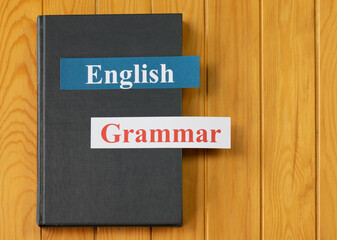 English cards on textbook on wooden board