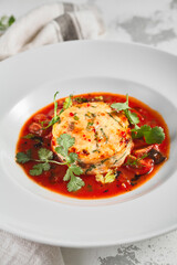Salmon fish cake with tomato sauce and fresh greens