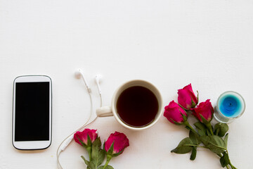 mobile phone ,hot coffee and rose flower of lifestyle woman relax in winter season arrangement on background white