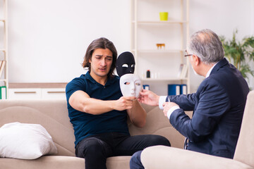 Young man wearing masks during psychotherapy session