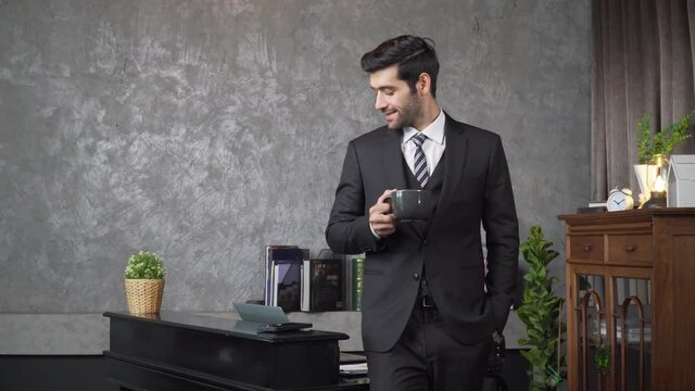 Footage B roll A Cheerful guy is working in office making mobile phone call and using laptop taking notes in notebook. Business communication. Work from home , business technology concept. 
