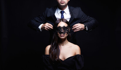 beautiful woman in mask and man in a suit